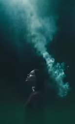 a woman is shown looking upward with the smoke billowing out of her mouth