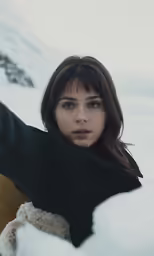 the girl is posing with her hands in the snow
