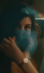 a woman with her hands around her face