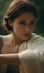 a woman in grey shirt holding onto a blanket