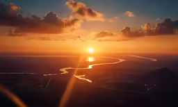 the sun setting over a wide river