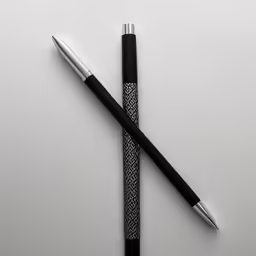 two pen with a decorative design next to each other
