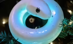 a lighted pretzel hanging from the top of a christmas tree