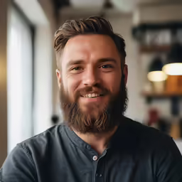 a man with a beard and a full grown smile