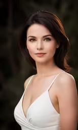 a woman posing for a picture while wearing white