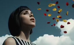 the woman is looking into the sky with colorful balloons in the air