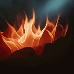 a hot flame with rocks in the foreground