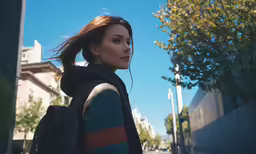a woman with long hair walking down the street