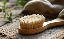 closeup of a white cupcake hairbrush on a wooden table