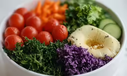 a colorful display of vegetables in a white bowl
