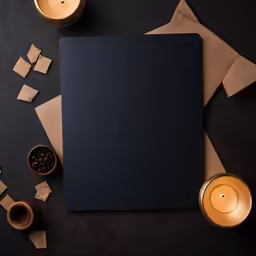 black square canvas, gold candles and other decorations