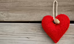 a heart that is hanging on a clothesline