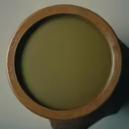 an old brown vase that has some type of base