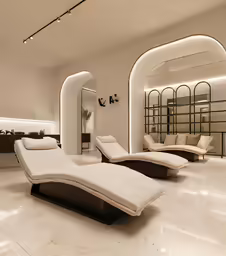 this living room is decorated in white with an elegant chaise lounge
