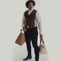 the man in a vest holds three bags