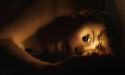 a doll that has eyes is laying down