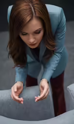 a person that is bent down on the chair