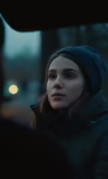 a woman is sitting outside at night with a car window open