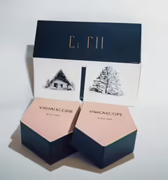 three boxes of different perfumes in a box
