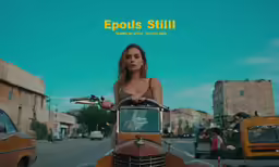 a young woman riding on the back of an orange motorcycle