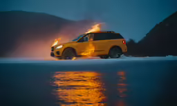 the car is driving down the snowy road