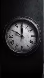 an old clock on a black surface reads 12 30