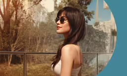 a woman looking away from the camera standing on a balcony