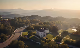 an aerial shot of a house with mountains in the background