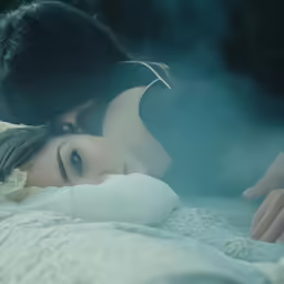 there is a woman laying down with a pillow