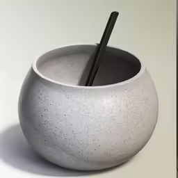 a bowl is filled with a chopstick next to a box