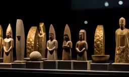 a display case with sculptures on it in an exhibit