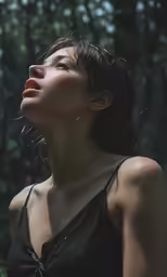 a beautiful young woman looking upwards into the sky