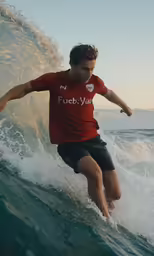 a man riding a wave on top of a surfboard