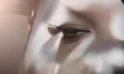 woman with long lashes looking up at the camera