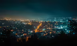 a city with lots of bright lights is shown from a distance
