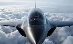 a jet is flying high above the clouds