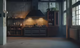 an open kitchen with a large light fixture above the stove