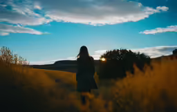 the person is looking at the grass on a hill