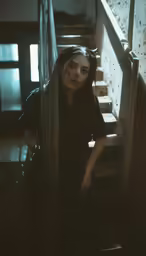 a young woman walking down a set of stairs