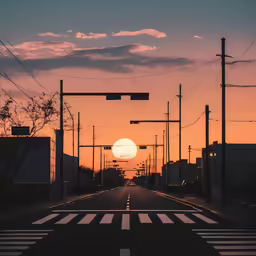 a street with sun coming up at the end