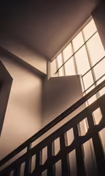 looking up an airy staircase with bright windows