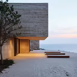 an exterior shot of two sets of wood benches on the beach