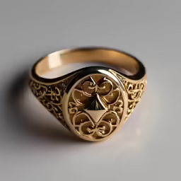 gold ring with black accents on a gray background