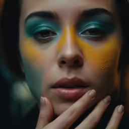 a woman with makeup on her face and green eyes