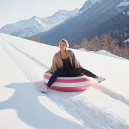 woman sitting in a pink and white striped tube
