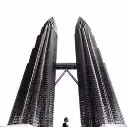 man standing between two tall buisnesss in the background