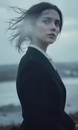 a woman is looking off into the distance