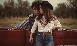 the man and woman are looking back at each other as they pose for a photo