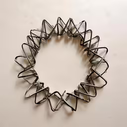 a circular object made from metal wire on a surface