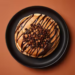 a piece of bread with chocolate toppings on a plate